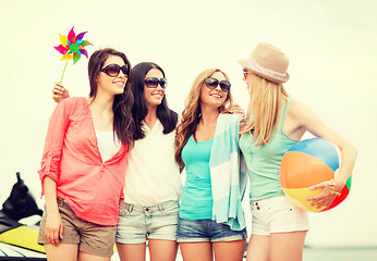 Image showing smiling girls in shades having fun on the beach