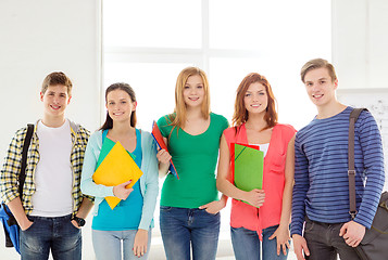 Image showing smiling students with bags and folders at school