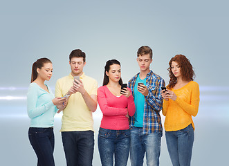 Image showing group of serious teenagers with smartphones