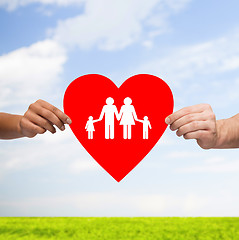 Image showing couple hands holding red heart with family