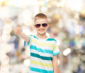 Image showing smiling little boy in sunglasses showing thumbs up