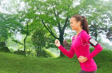 Image showing smiling young woman running outdoors