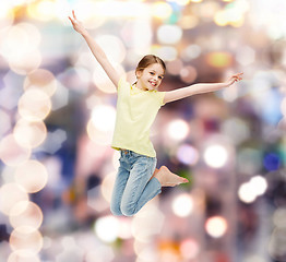 Image showing smiling little girl jumping