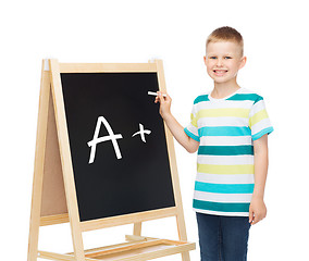 Image showing smiling little boy with blank blackboard