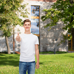 Image showing smiling man in white t-shirt showing thumbs up