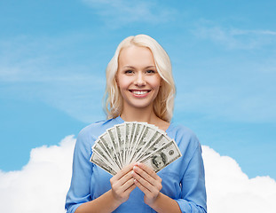 Image showing smiling young woman with us dollar money