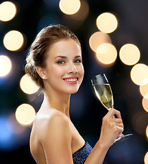 Image showing smiling woman holding glass of sparkling wine