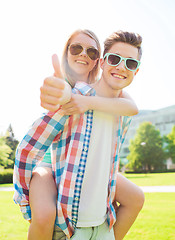 Image showing smiling couple having fun and showing thumbs up