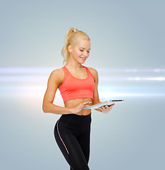 Image showing smiling sporty woman with tablet pc computer