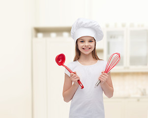 Image showing smiling girl in cook hat with ladle and whisk