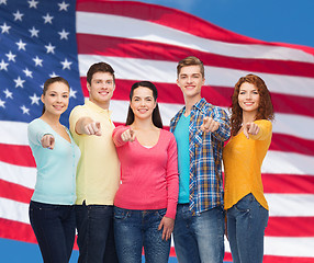 Image showing group of smiling teenagers over american flag