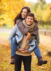 Image showing smiling couple hugging in autumn park