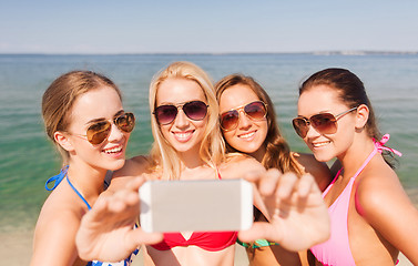 Image showing group of smiling women making selfie on beach