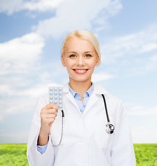 Image showing smiling female doctor with pills