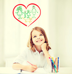 Image showing smiling little student girl drawing at school