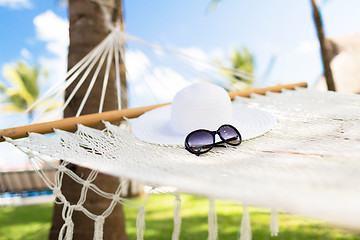 Image showing picture of hammock with white hat and sunglasses