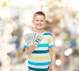 Image showing smiling boy holding dollar cash money in his hand