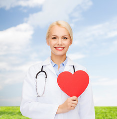 Image showing smiling female doctor with heart and stethoscope