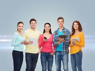 Image showing group of teenagers with smartphones and tablet pc