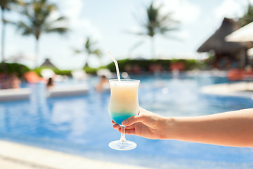 Image showing close-up of hand holding glass with cocktail