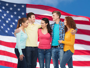 Image showing group of smiling teenagers over american flag