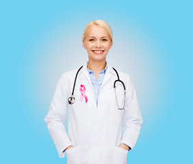 Image showing doctor with stethoscope, cancer awareness ribbon