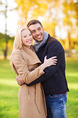 Image showing smiling couple hugging in autumn park