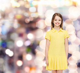 Image showing smiling little girl in yellow dress