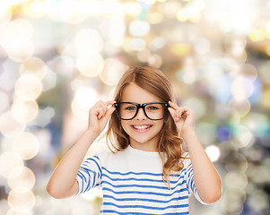 Image showing smiling cute little girl with black eyeglasses