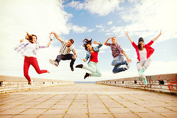 Image showing group of teenagers jumping