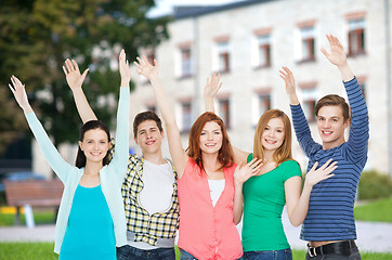 Image showing group of smiling students waving hands