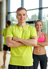 Image showing smiling man and woman in gym