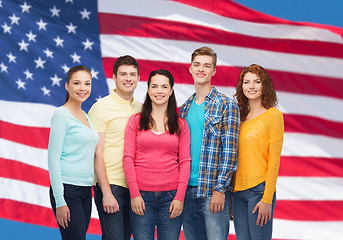 Image showing group of smiling teenagers over american flag