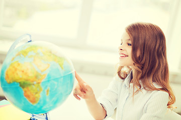 Image showing smiling student girl with globe at school