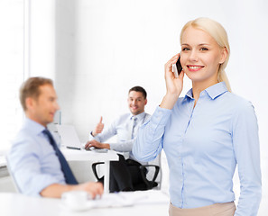 Image showing young smiling businesswoman with smartphone