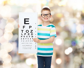 Image showing smiling boy in eyeglasses with white blank board