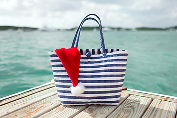 Image showing close up of beach bag and santa helper hat