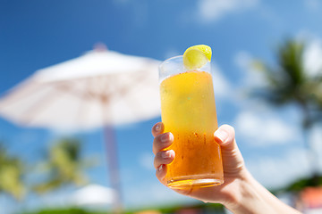 Image showing close-up of hand holding glass with cocktail