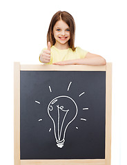 Image showing smiling girl with blackboard showing thumbs up