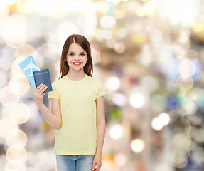 Image showing smiling little girl with ticket and passport