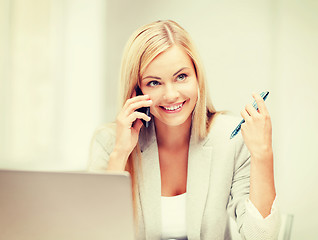 Image showing businesswoman with laptop and cell phone