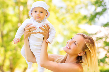 Image showing happy mother with little baby in park