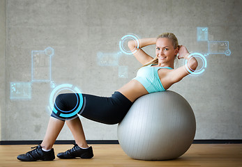 Image showing smiling woman with exercise ball in gym