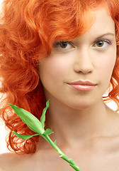 Image showing lovely redhead with bamboo