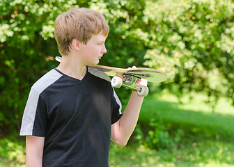 Image showing Young skater with skateboard on shoulder