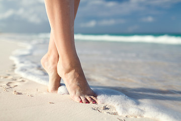 Image showing closeup of woman legs on sea shore