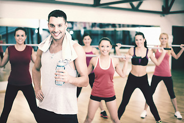 Image showing smiling trainer in front of group of people