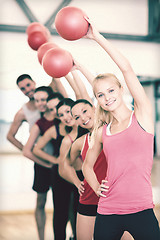 Image showing group of smiling people working out with ball