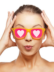 Image showing surprised teenage girl in pink sunglasses