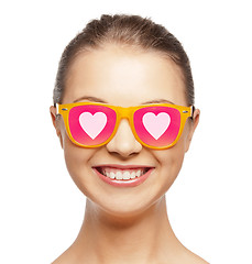 Image showing smiling teenage girl in pink sunglasses